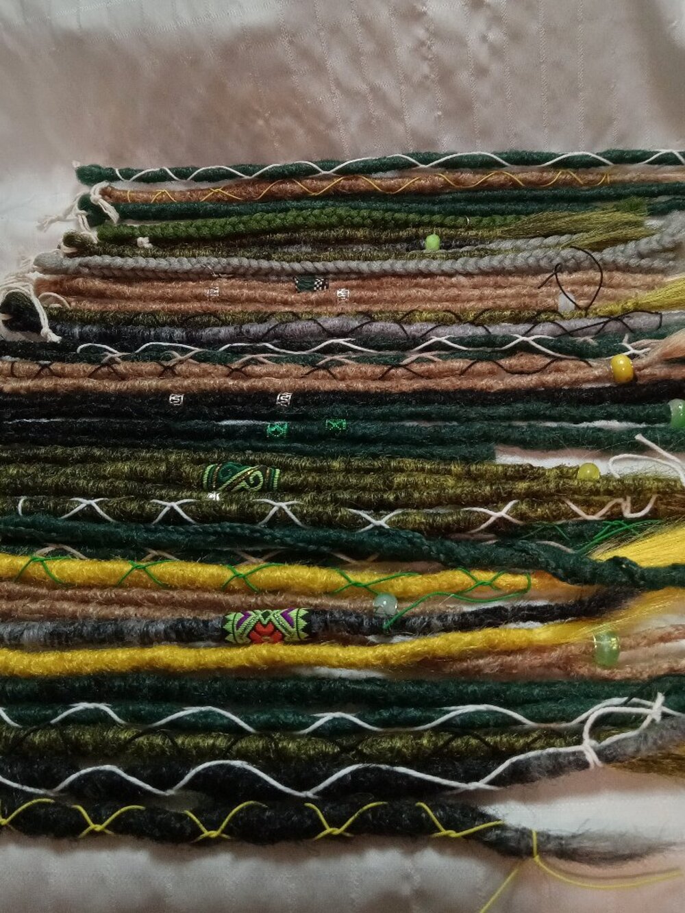 A full head of dreadlocks and braids, handmade from soft synthetic materials